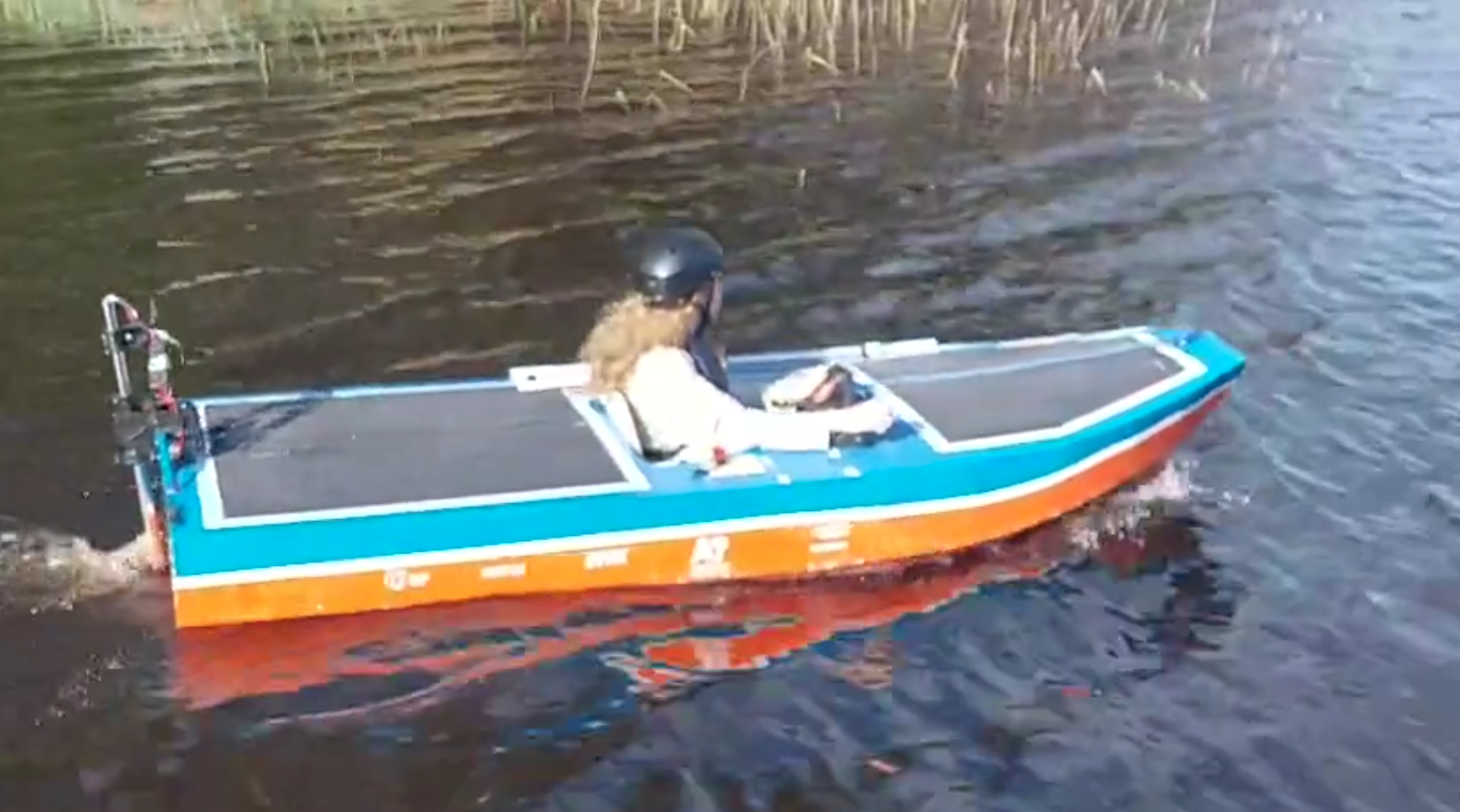 Student in colorful solar boat